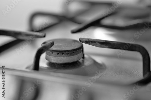 used burner and grill on a gas stove, bw photo