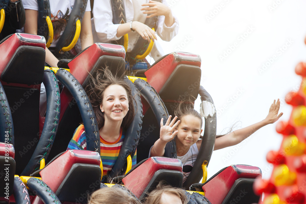 Young friends on roller coaster ride. Stock Photo Adobe Stock