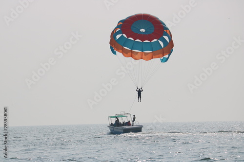 Parasailing with boat in sea