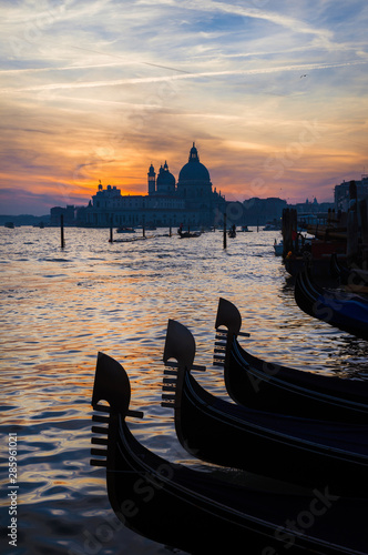 Beautiful sunset over Venice Lagoon with gondola characteristic iron bows © crisfotolux