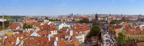 Beautiful panorama of Charles bridge (Karluv Most), Vltava river and red roofs from the Bridge Tower