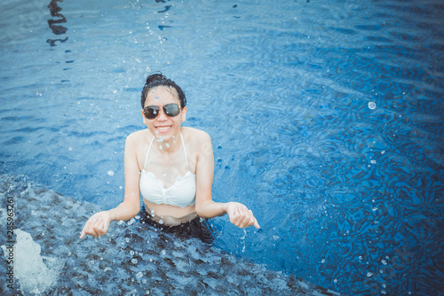 Asian girl in a white bikin...