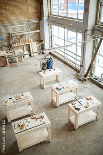 Wide angle background of workstations table in industrial woodworking shop, copy space