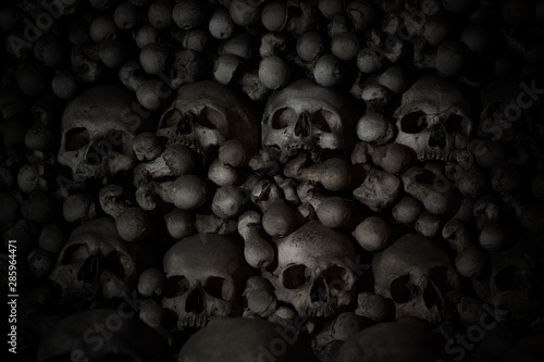 Numerous creepy skulls in the dark. Abstract concept symbolizing death, terror, and evil.