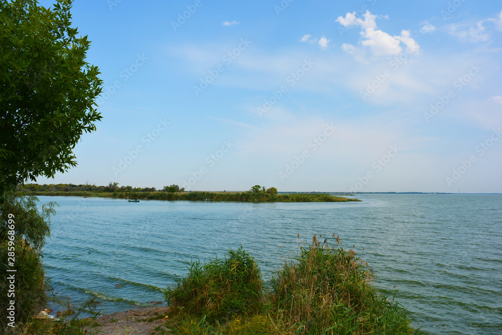 Beautiful view of the Samara River with picturesque steep banks and coast, trees, greenery and rich sky. Bright and unforgettable nature in the housing estate, Shevchenko, Dnipro, Ukraine. Beautiful view of the Samara River with picturesque steep banks and coast, trees, greenery and rich sky. Bright and unforgettable nature in the housing estate, Shevchenko, Dnipro, Ukraine.