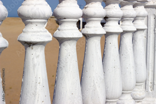 Balustrade Pillars, close up photo. White pillars in a row. grey posts in a row.