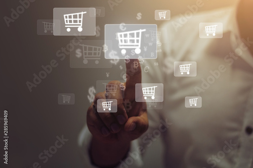 Fototapeta Naklejka Na Ścianę i Meble -  Businessman pressing  on virtual touch screen.online shopping concept.