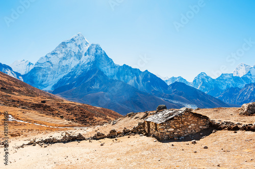 Stone house in the mountains and view of Mount Ama Dablam in Himalayas, Nepal. Khumbu valley, Everest region