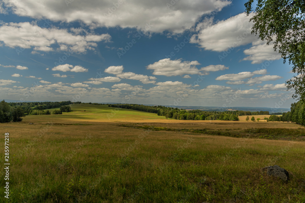 Meadows and pasture land near vanished village Smrkovec in summer hot day