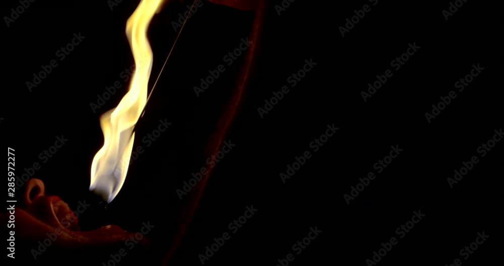 fire show. a man swallows a burning torch in his mouth and extinguishes it there in the dark