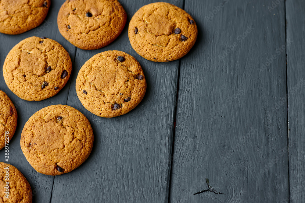 Chocolate cookies on a dark wooden table. Top view. Chocolate cookies on a dark wooden table. Top view.