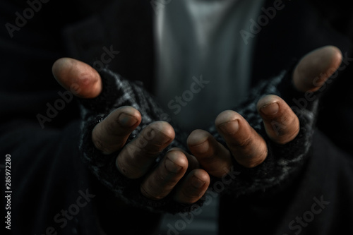 hands close up poor old man or beggar begging you for help sitting at dirty slum. Concept for poverty or hunger people,human Rights,donate and charity. © Aliaksandr Marko