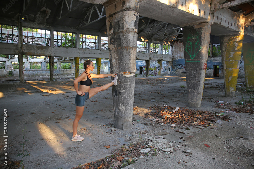 Fitness girl stretching after training outdoors Fitness girl stretching after training outdoors