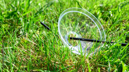 Environmental pollution: plastic cap lies in the grass.