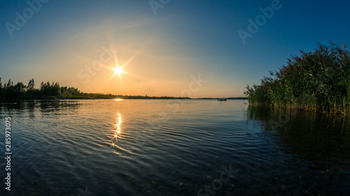 Beautiful summer sunset over a lake © DZiegler