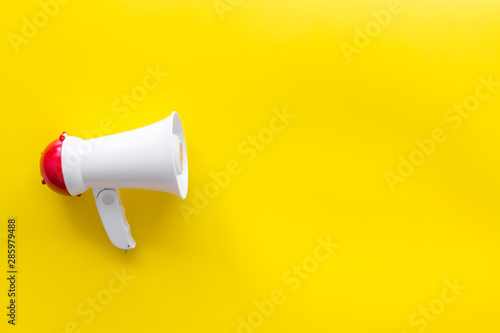 loudspeaker for announcement on yellow background top view mock-up