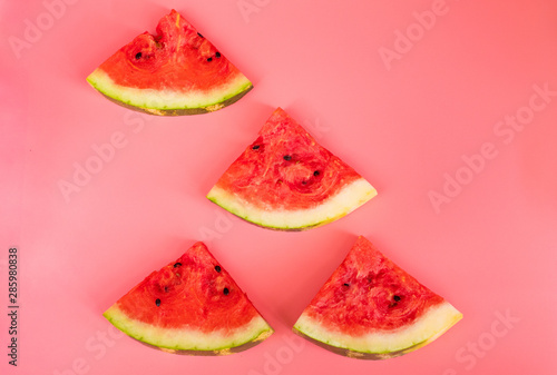 Watermelon slices on a pink background. Healthy food concept.