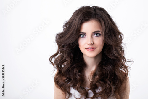 Portrait of beautiful girl with luxuriant hair curling.