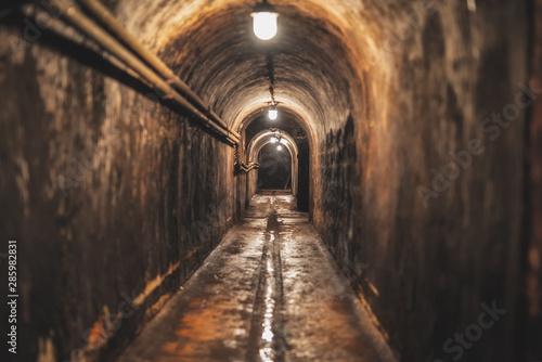 long dark narrow underground tunnel with lighting © vadimalekcandr