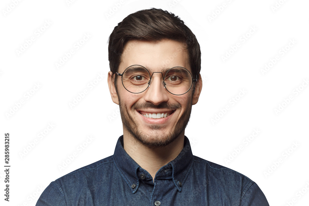 Headshot of smiling handsome man with trendy haircut and round glasses isolated on white  background