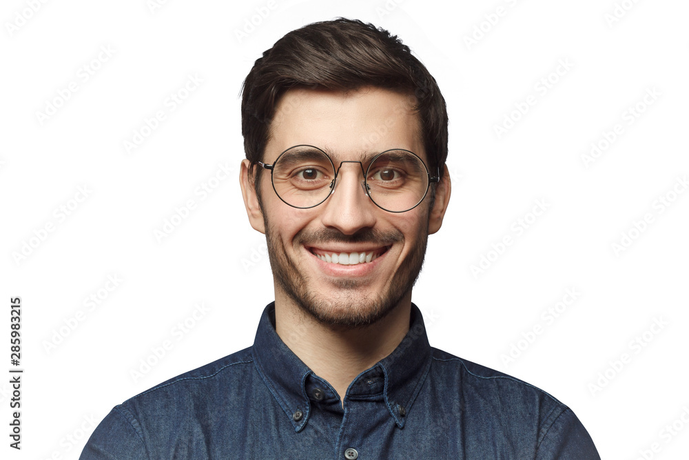 Headshot of smiling handsome man with trendy haircut and round glasses isolated on white background Headshot of smiling handsome man with trendy haircut and round glasses isolated on white background