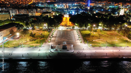 Aerial drone night shot of famous promenade area in new waterfront of Thessaloniki or Salonica featuring Alexander the Great statue, North Greece