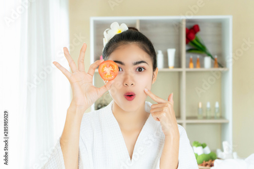 Young woman enjoyment happy treatment spa with tomato in beauty salon