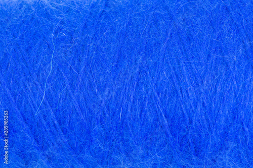 background of fluffy blue angora wool on a cone