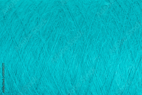 background of fluffy green mohair wool on a cone photo