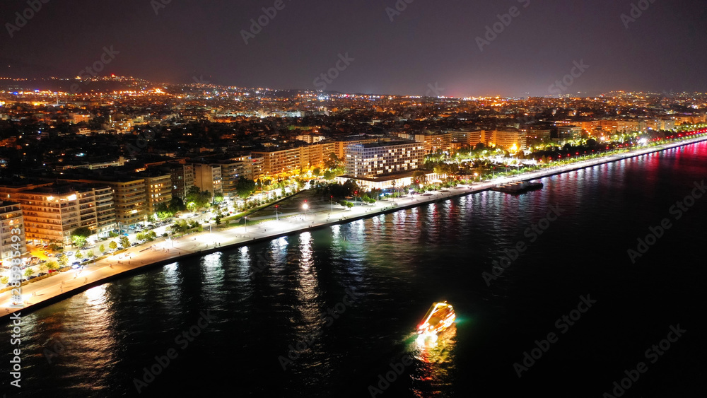 Aerial drone night shot of famous promenade area in new waterfront of Thessaloniki or Salonica featuring Alexander the Great statue, North Greece