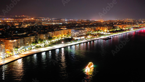 Aerial drone night shot of famous promenade area in new waterfront of Thessaloniki or Salonica featuring Alexander the Great statue  North Greece