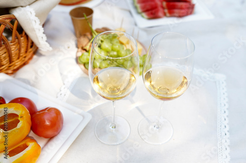 picnic with wine, vegetables and fruits on white background. tasty dinner
