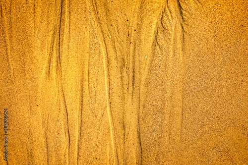 Golden sand with patterns formed by the sea photo