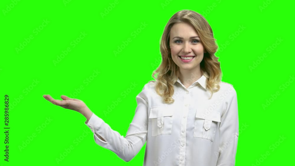 Smiling woman presenting something with open hand palm. Cute woman showing copy space on her palm. Selling time concept. Smiling woman presenting something with open hand palm. Cute woman showing copy space on her palm. Selling time concept.