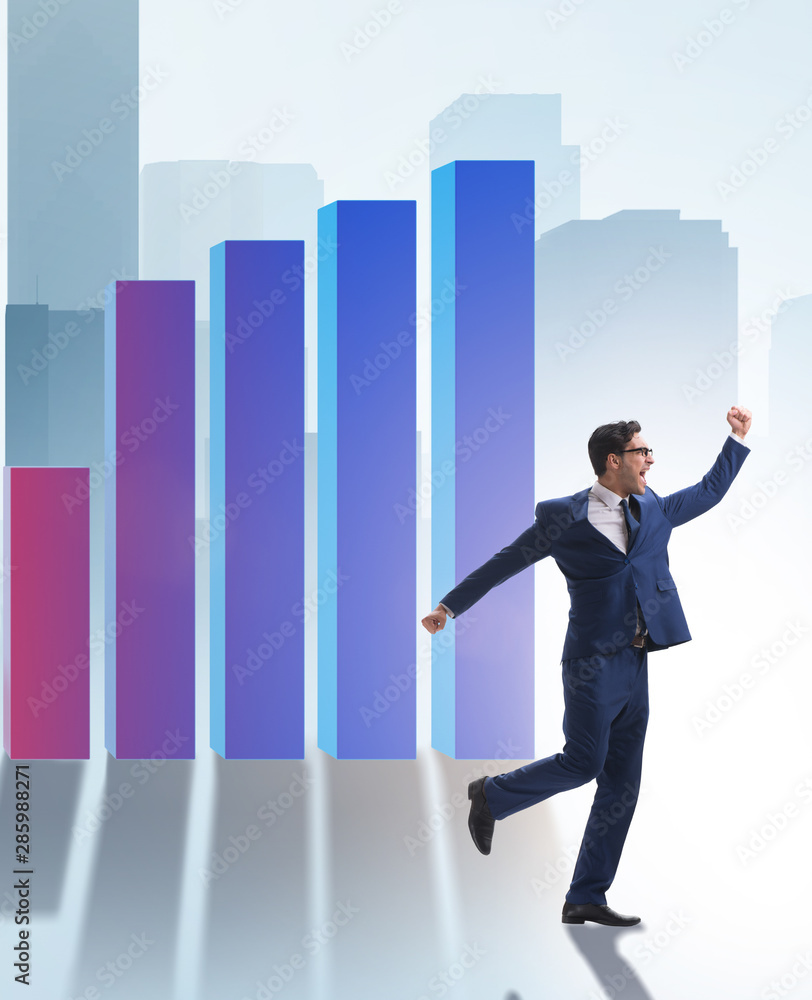 Young businessman in business concept with bar charts Young businessman in business concept with bar charts