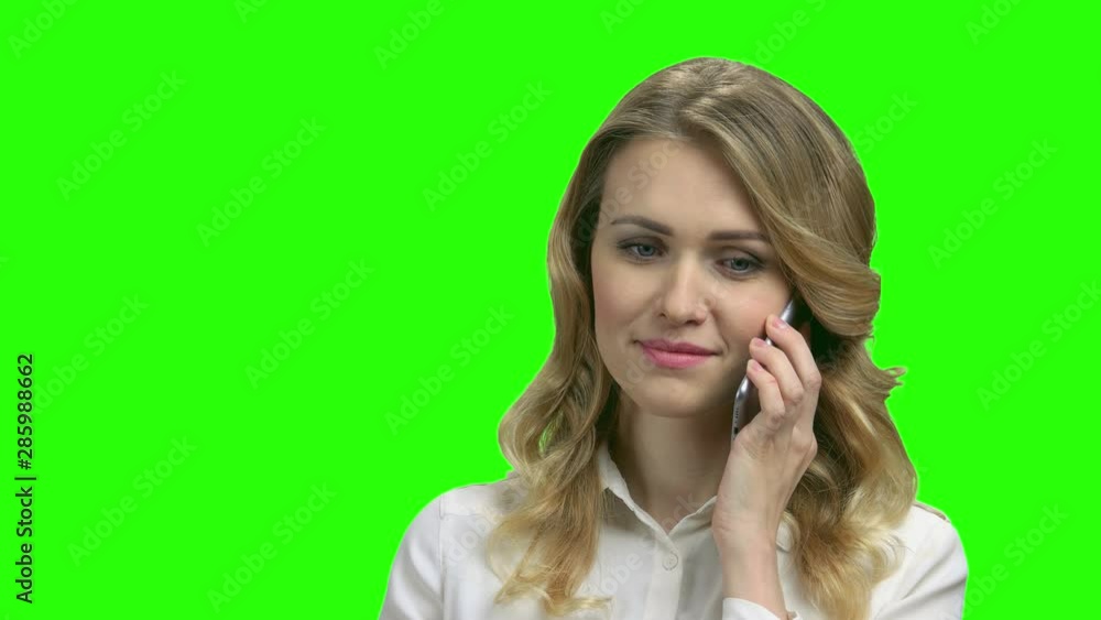 Young confident business lady talking on cell phone. Pretty caucasian business woman using mobile phone on green screen background. Young confident business lady talking on cell phone. Pretty caucasian business woman using mobile phone on green screen background.