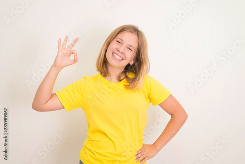 Wallpaper Mural Portrait of a cheerful teenager girl showing okay gesture. Health, education and people concept. Torontodigital.ca