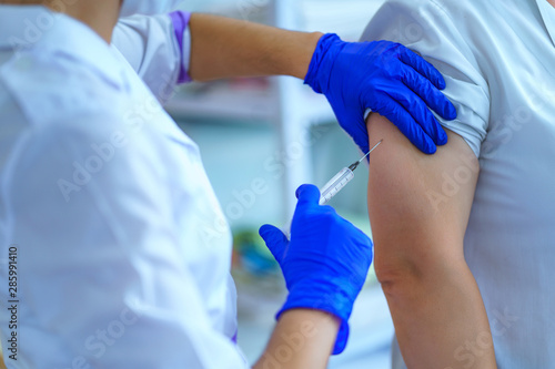 Nurse vaccinated patient against flu and measles during an epidemic. Flu shot  protection and prevention of viral infectious diseases
