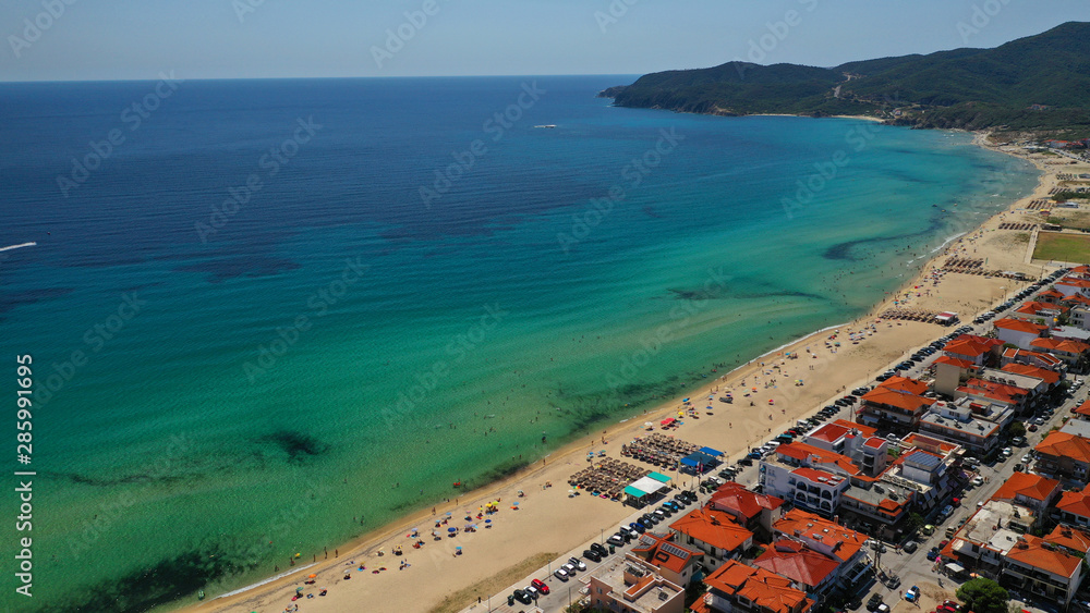 Fototapeta premium Aerial drone photo of famous village and long sandy beach of Sarti in South Sithonia, Halkidiki, Greece