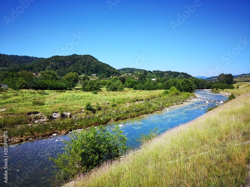 River in the mountains - Summer landscape with river surrounded by hills 