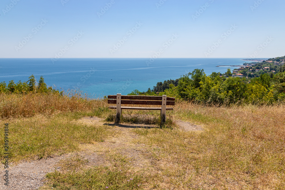 Empty bench on the hill. Seascape on the background. Greece travel concept.