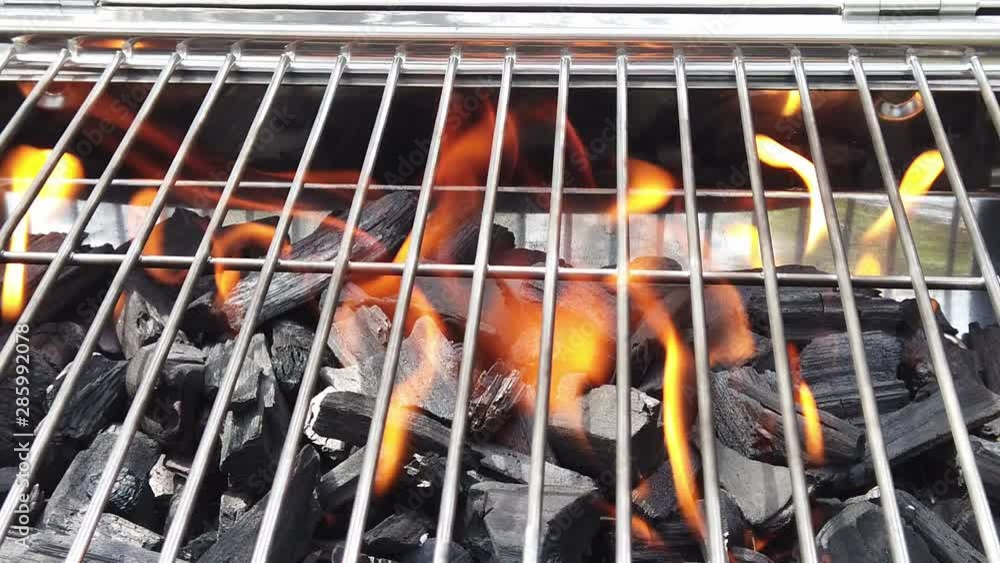 Flames in charcoal grill. Close up slow motion video. Flames in charcoal grill. Close up slow motion video.