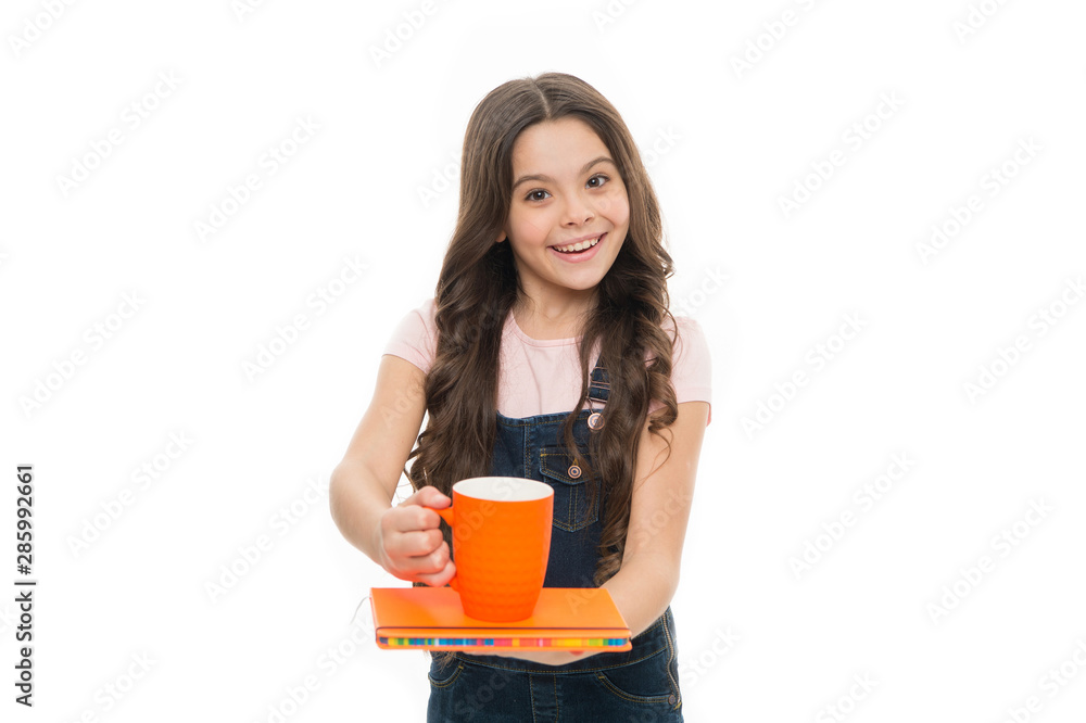Energize your morning. Little kid drinking morning tea or milk. School child having breakfast in morning. Cute schoolgirl holding cup and note book. Small girl enjoying her energetic morning meal Energize your morning. Little kid drinking morning tea or milk. School child having breakfast in morning. Cute schoolgirl holding cup and note book. Small girl enjoying her energetic morning meal