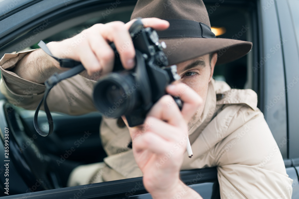 Photographer using camera in his car Photographer using camera in his car