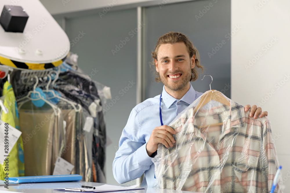 Worker of modern dry-cleaner's at reception