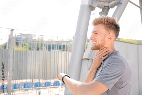 Sporty young man checking h...