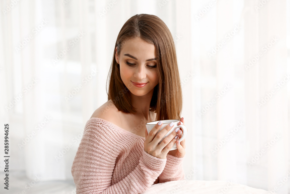 Beautiful young woman drinking tea at home Beautiful young woman drinking tea at home