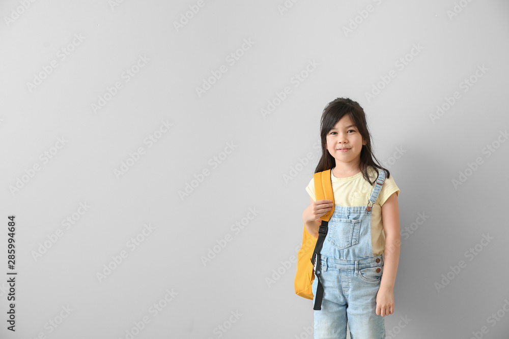 Portrait of little schoolgirl on light background Portrait of little schoolgirl on light background