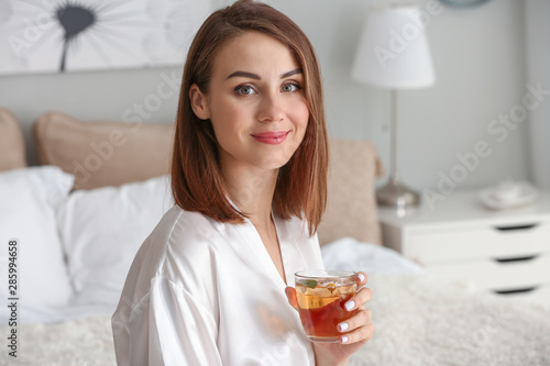 Beautiful young woman drink...