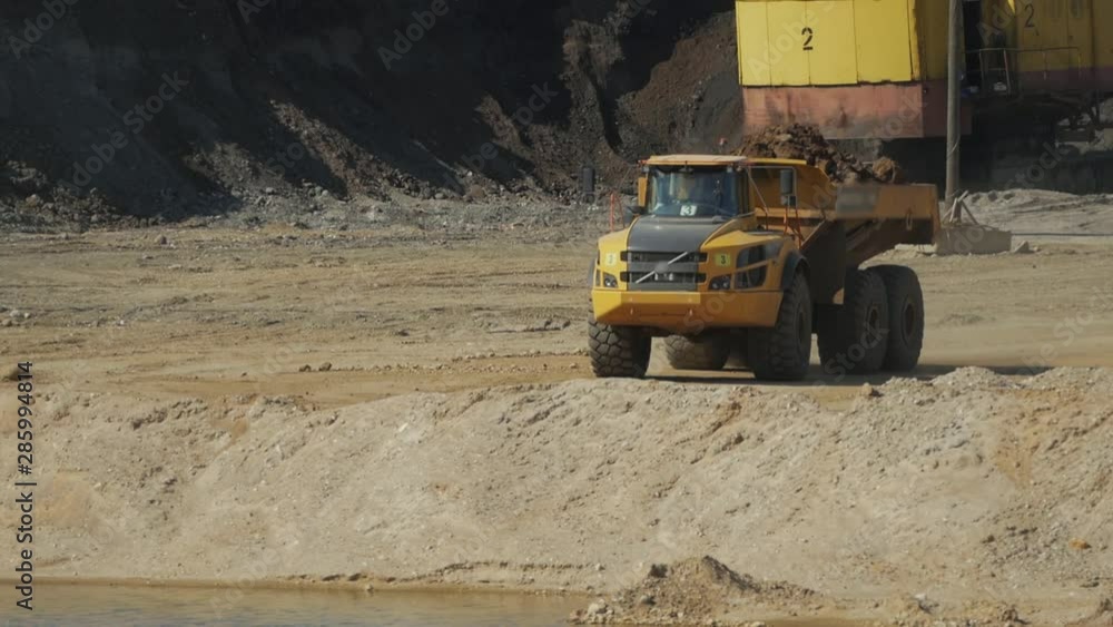 a loaded mining truck slowly moves along a quarry a loaded mining truck slowly moves along a quarry
